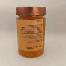 Load image into Gallery viewer, Jar of honey with a copper lid on a light gray background